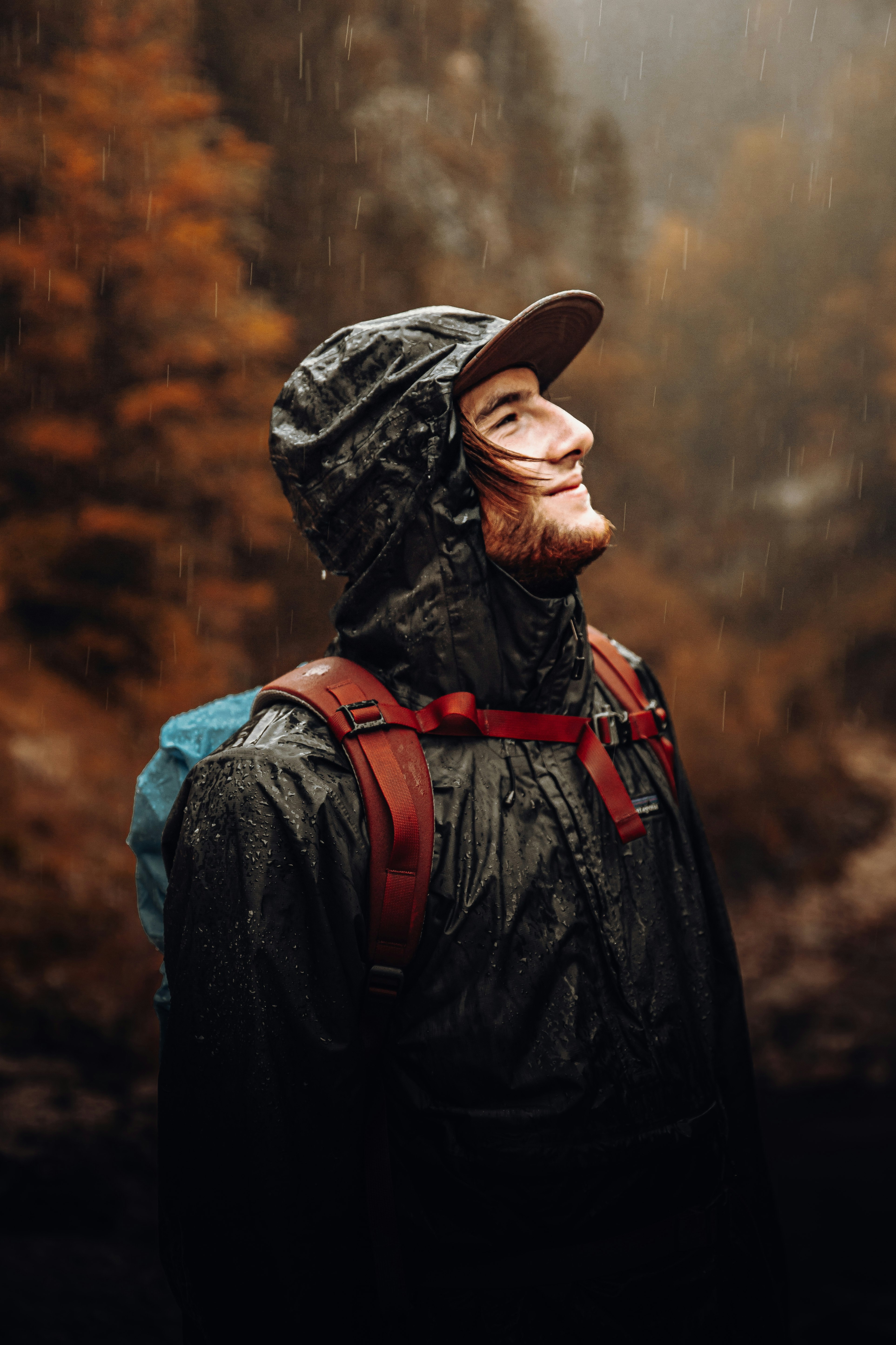 man in black and red jacket wearing black hat